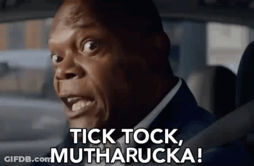 A Man In A Suit Is Driving A Car And Says Tick Tock , Mutharucka ! GIF