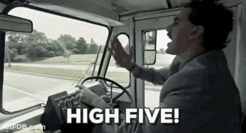 A Man In A Suit Is Driving A Truck And Shouting . GIF