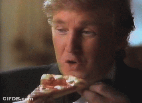 A Man In A Suit Is Eating A Piece Of Pizza GIF