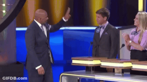A Man In A Suit Is Giving A High Five To Another Man On A Television Show GIF