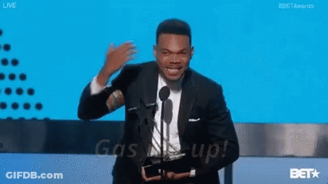 A Man In A Suit Is Giving A Speech At A Bet Awards GIF