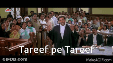 A Man In A Suit Is Giving A Speech In Front Of A Crowd With The Words " Tareef Pe Tareef " Written Below Him GIF