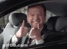 A Man In A Suit Is Giving A Thumbs Up In A Car GIF