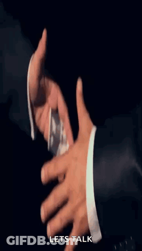 A Man In A Suit Is Handing Another Man A Stack Of Money With The Words Let 'S Talk Below It GIF