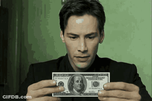 A Man In A Suit Is Holding A 10 Dollar Bill GIF