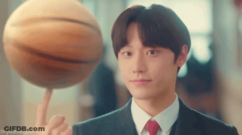 A Man In A Suit Is Holding A Basketball On His Finger GIF