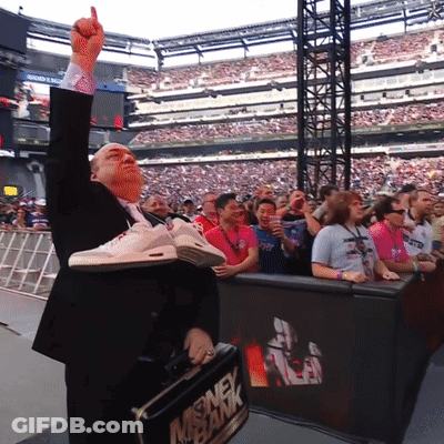 A Man In A Suit Is Holding A Briefcase That Says Money Bank On It GIF
