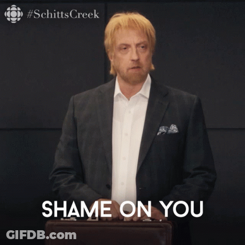 A Man In A Suit Is Holding A Briefcase With The Words Shame On You Below Him GIF