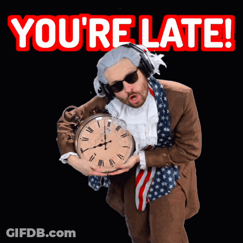 A Man In A Suit Is Holding A Clock With The Words You 'Re Late Behind Him GIF