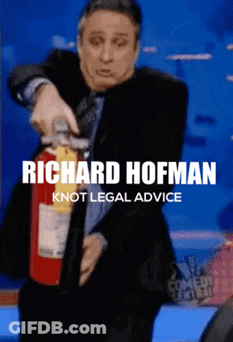 A Man In A Suit Is Holding A Fire Extinguisher And The Caption Says Richard Hofman GIF