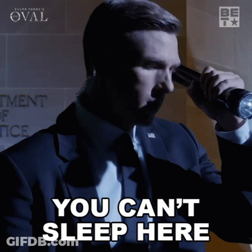 A Man In A Suit Is Holding A Flashlight And Says You Can T Sleep Here GIF