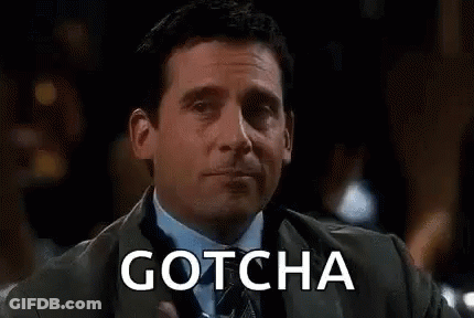 A Man In A Suit Is Holding A Glass Of Water And The Word Gotcha Is On The Screen Behind Him . GIF