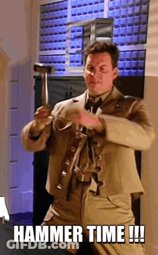 A Man In A Suit Is Holding A Hammer And Says " Hammer Time !!! " GIF