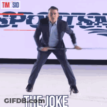 A Man In A Suit Is Holding A Hockey Stick In Front Of A Sports Radio Logo GIF