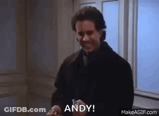 A Man In A Suit Is Holding A Key In His Hand And Saying `` Andy '' . GIF