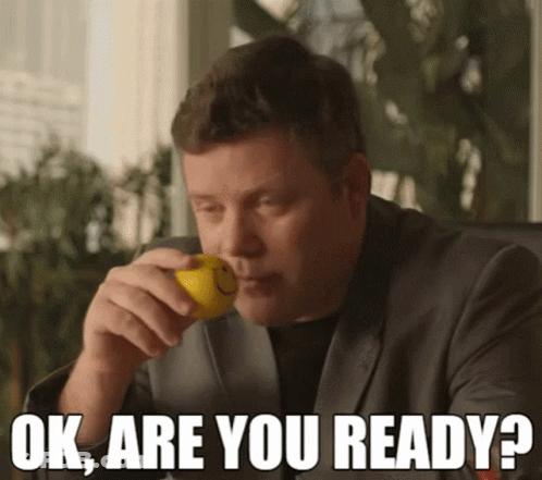 A Man In A Suit Is Holding A Lemon In His Mouth With The Words Ok Are You Ready Below Him GIF