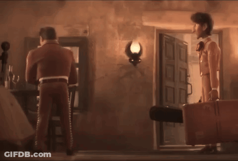 A Man In A Suit Is Holding A Light While Standing Next To A Woman GIF