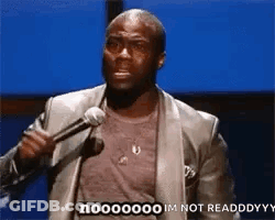 A Man In A Suit Is Holding A Microphone And Saying `` Im Not Readdddyy '' . GIF