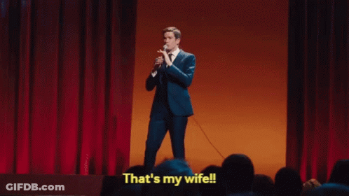 A Man In A Suit Is Holding A Microphone And Saying That 'S My Wife . GIF