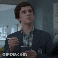 A Man In A Suit Is Holding A Pen And A Notepad GIF
