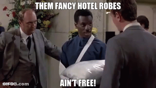 Man In Suit Holding Pillow Says Them Fancy Hotel Robes Ain't Free GIF