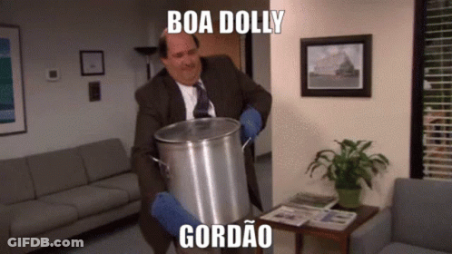 A Man In A Suit Is Holding A Pot With The Words Boa Doliy Gordao Written On It GIF