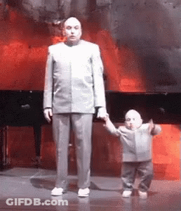 A Man In A Suit Is Holding A Small Child 'S Hand . GIF