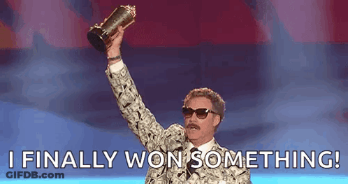 A Man In A Suit Is Holding A Trophy In His Hand And Saying `` I Finally Won Something '' . GIF
