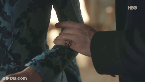 A Man In A Suit Is Holding Another Man 'S Hand . GIF