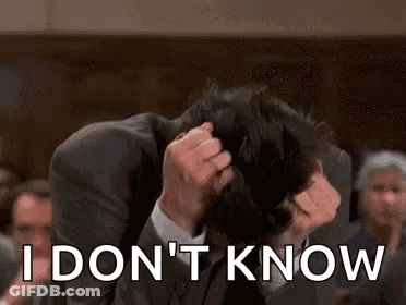 A Man In A Suit Is Holding His Head And Says `` I Don T Know '' . GIF