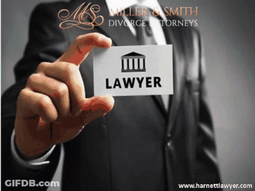 A Man In A Suit Is Holding Up A Business Card For A Lawyer GIF