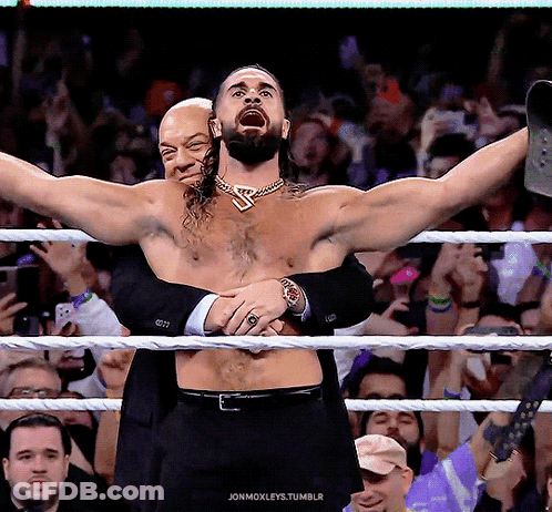 A Man In A Suit Is Hugging Another Man In A Wrestling Ring With The Words Jonmoxleys.tumblr Written Below GIF