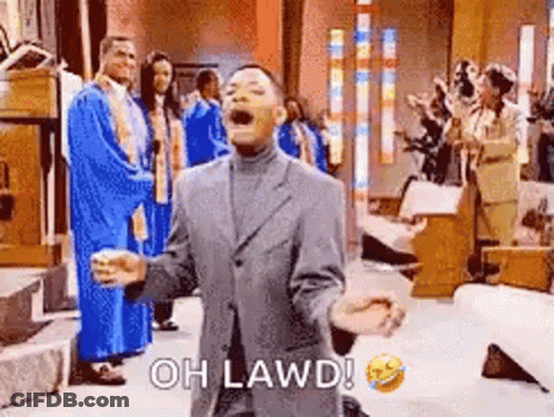A Man In A Suit Is Kneeling Down In Front Of A Group Of People In A Church And Laughing . GIF