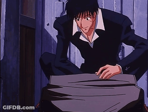 A Man In A Suit Is Kneeling Down In Front Of A Wooden Door GIF