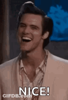 A Man In A Suit Is Laughing And Saying Nice . GIF