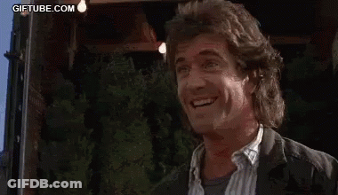A Man In A Suit Is Laughing While Being Punched In The Face By A Woman . GIF
