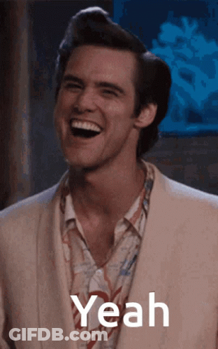 A Man In A Suit Is Laughing With The Word Yeah In The Corner GIF