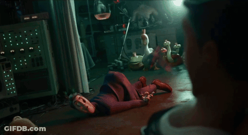 A Man In A Suit Is Looking At Another Man In A Dark Room GIF