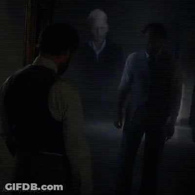 A Man In A Suit Is Looking At His Reflection In A Mirror With The Words Johnny Depp Gifs Below Him GIF