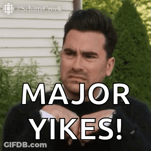 A Man In A Suit Is Making A Face And Says Major Yikes ! GIF