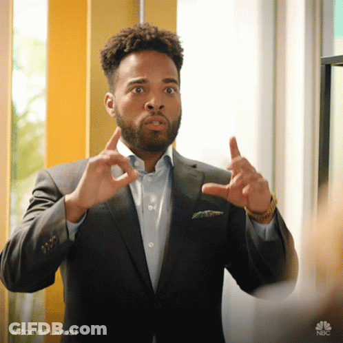 A Man In A Suit Is Making A Funny Face And Has The Hashtag #Zoeysplaylist At The Bottom GIF