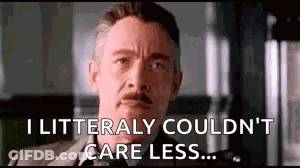 A Man In A Suit Is Making A Funny Face And Saying `` I Litterally Couldn 'T Care Less ... '' GIF