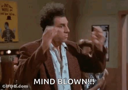 A Man In A Suit Is Making A Funny Face And Says `` Mind Blown ! '' GIF