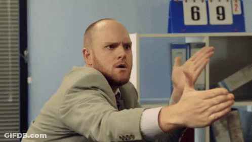 Man In Suit Making Funny Face By Scoreboard GIF