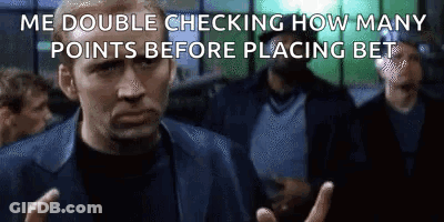 A Man In A Suit Is Making A Funny Face While Standing In Front Of A Crowd Of People . GIF