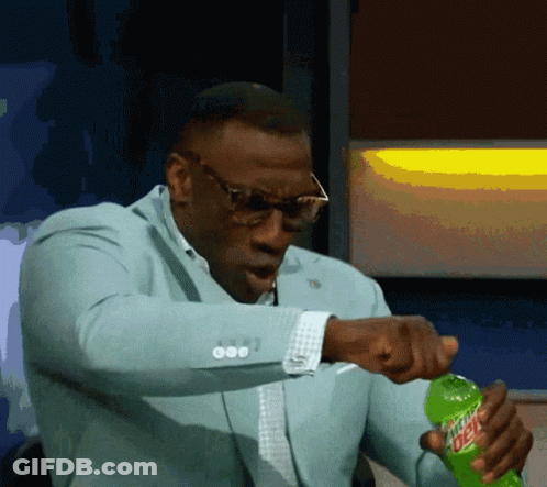A Man In A Suit Is Opening A Bottle Of Mtn Dew GIF