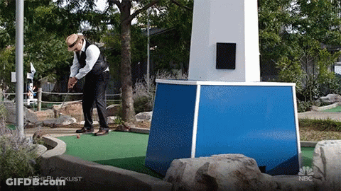 A Man In A Suit Is Playing A Game Of Golf On A Nbc Show Called The Blacklist GIF