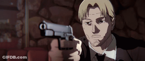 A Man In A Suit Is Pointing A Gun At The Camera GIF