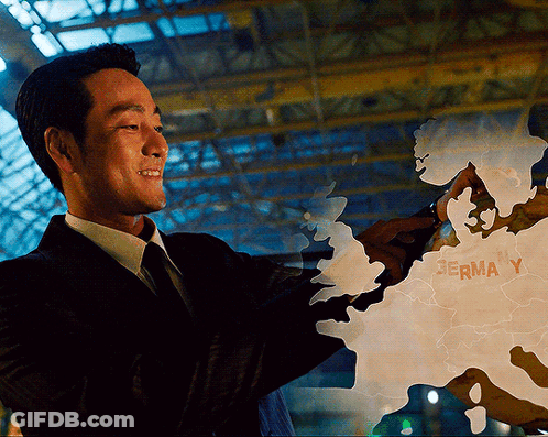 A Man In A Suit Is Pointing At A Map That Says Germa Y On It GIF