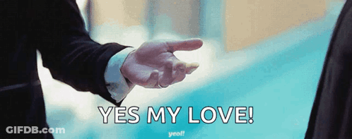 A Man In A Suit Is Pointing At Another Man With The Words Yes My Love Written Below Him GIF